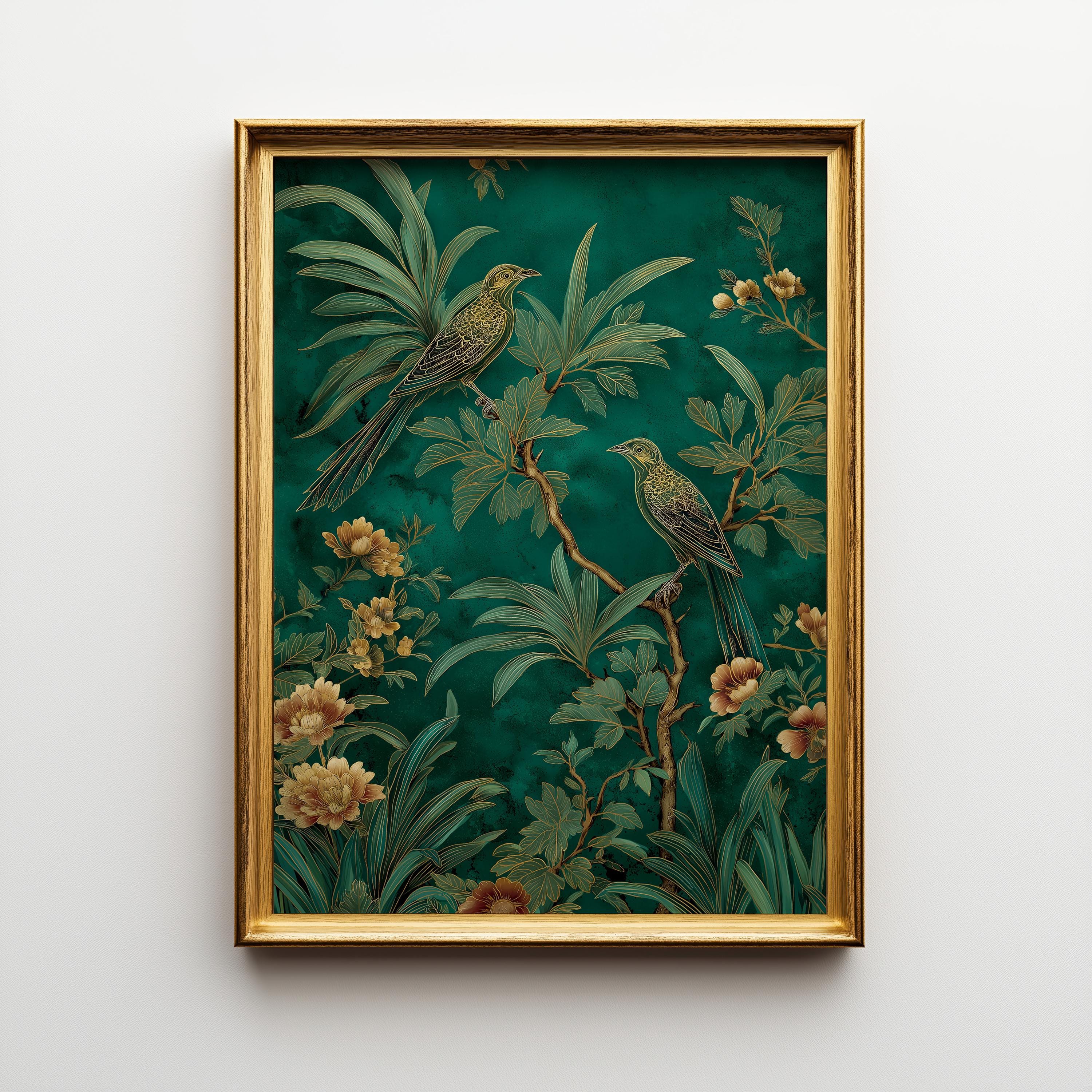A framed art print featuring two green birds perched among lush tropical foliage and yellow flowers on a dark teal background, enclosed in a gold frame and hanging on a light gray wall.