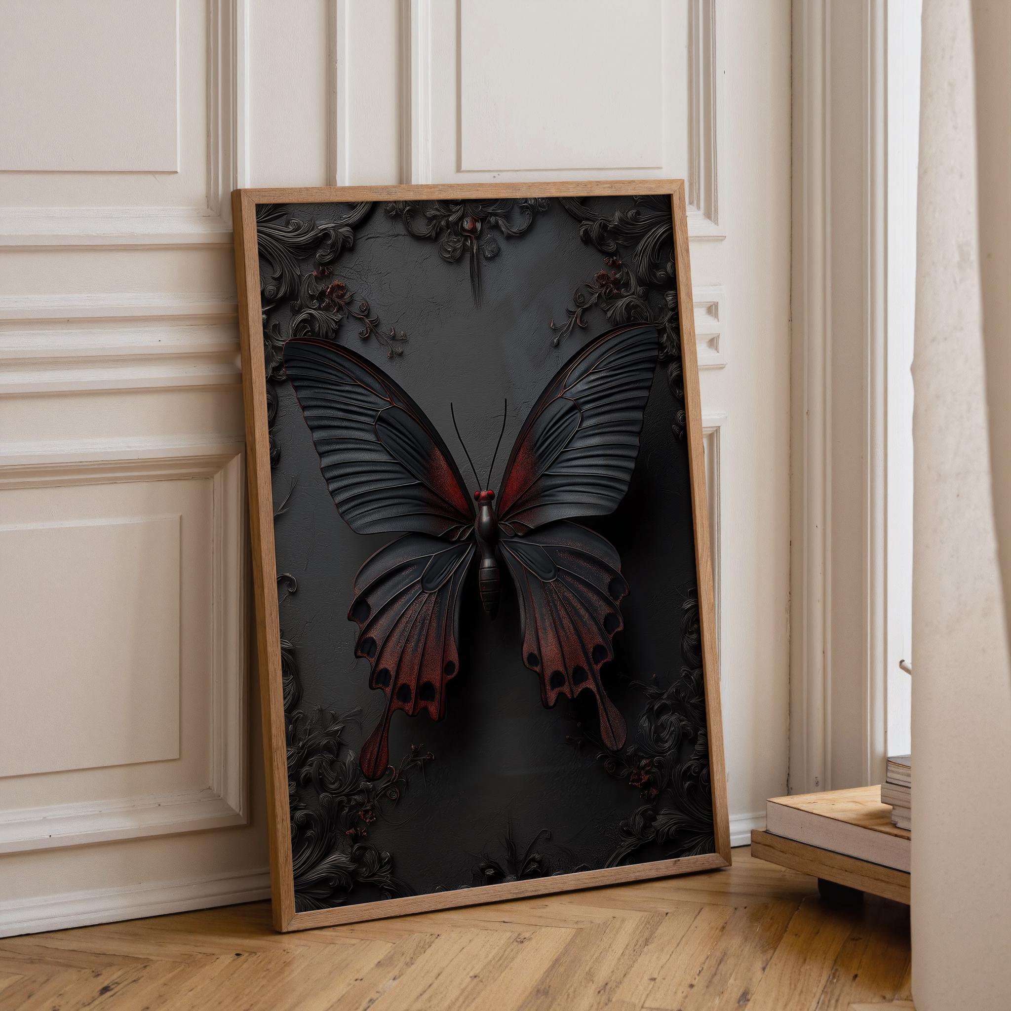 A framed wall art print leaning against a cream paneled wall on a light wood floor. The artwork shows a large black butterfly with reddish-brown wings over a dark floral background, enclosed in a light wood frame.