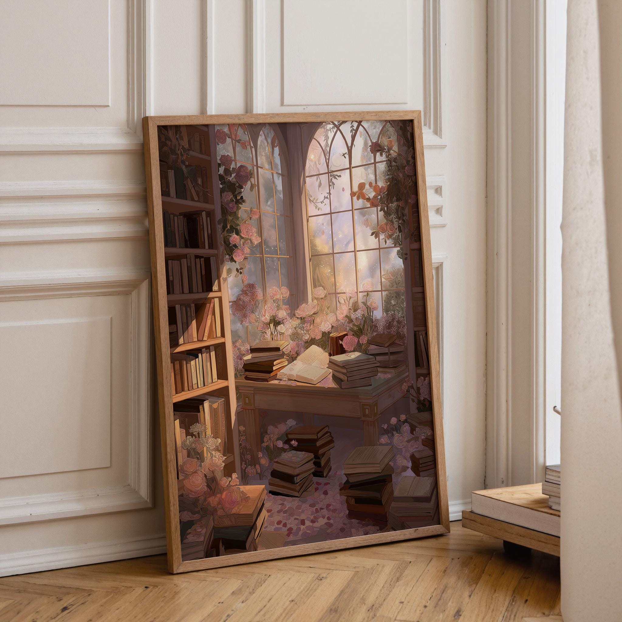 A large framed art print depicting a cozy, sunlit library scene with bookshelves, stacks of books, and a large arched window with pink cherry blossoms, leaning against a white paneled wall on a wooden floor.